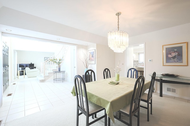 dining room featuring visible vents, light colored carpet, light tile patterned floors, recessed lighting, and an inviting chandelier