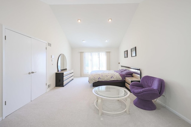 bedroom featuring visible vents, light colored carpet, and high vaulted ceiling