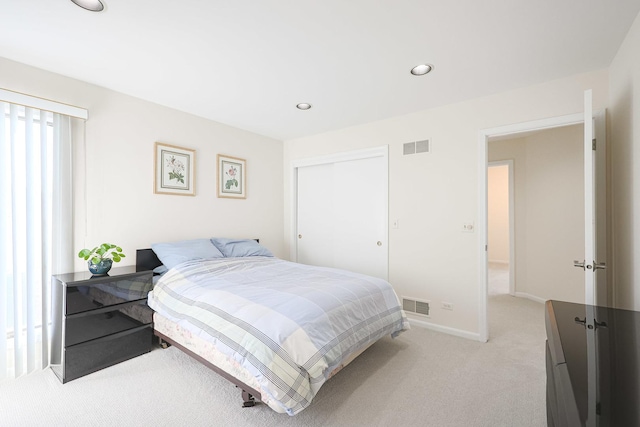 bedroom with recessed lighting, light colored carpet, visible vents, and baseboards