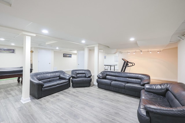 living area with recessed lighting, baseboards, and wood finished floors