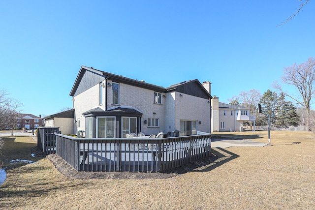 rear view of house with a residential view, a chimney, and a deck