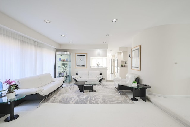 living area featuring recessed lighting and baseboards