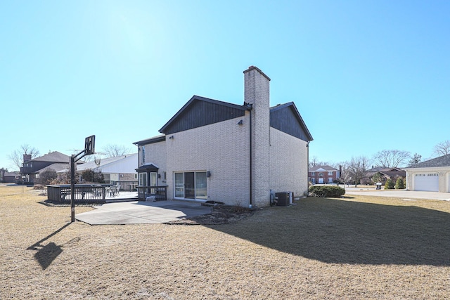 back of house featuring a patio and a chimney