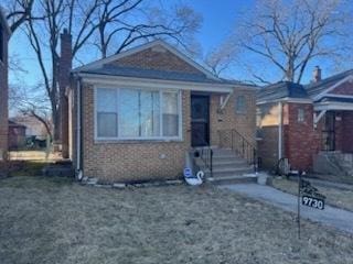 view of front of home with brick siding and a chimney