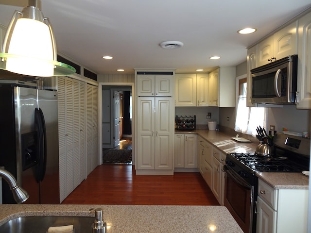 kitchen featuring white cabinetry, recessed lighting, wood finished floors, and stainless steel appliances