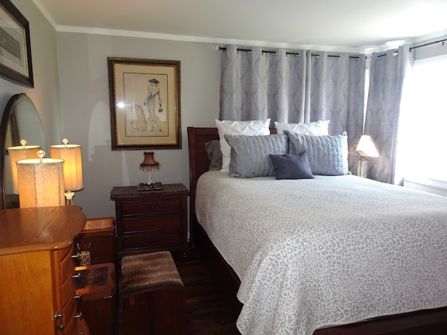 bedroom featuring dark wood finished floors and crown molding