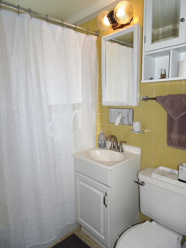 full bath with tasteful backsplash, toilet, tile walls, and vanity