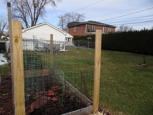 view of yard with fence and a garden