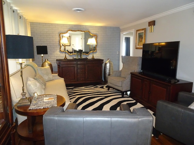 living area featuring brick wall and crown molding