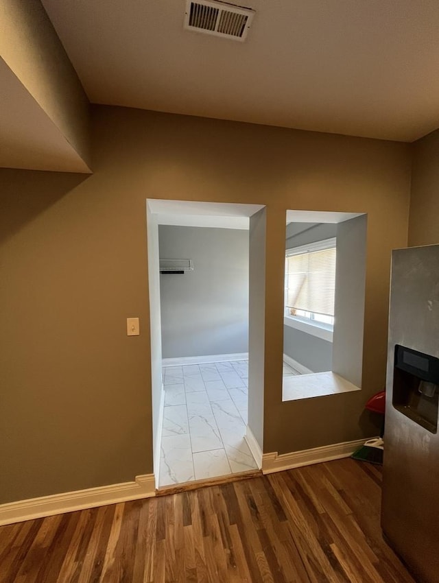 interior space featuring marble finish floor, visible vents, and baseboards