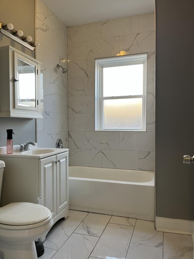 full bath with marble finish floor, shower / bath combination, vanity, and toilet