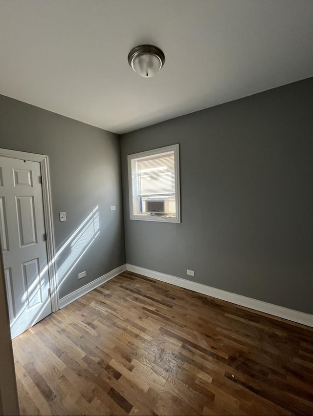 unfurnished room featuring wood finished floors and baseboards