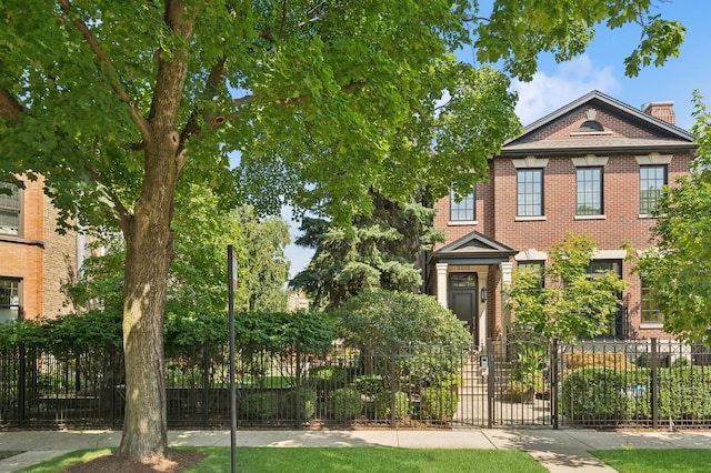 view of front facade featuring brick siding and fence