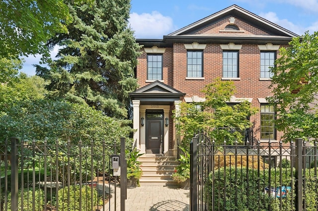 view of front facade featuring a fenced front yard and brick siding