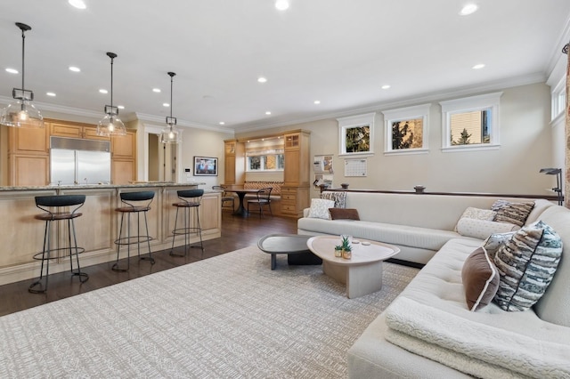 living area with crown molding, dark wood finished floors, and recessed lighting