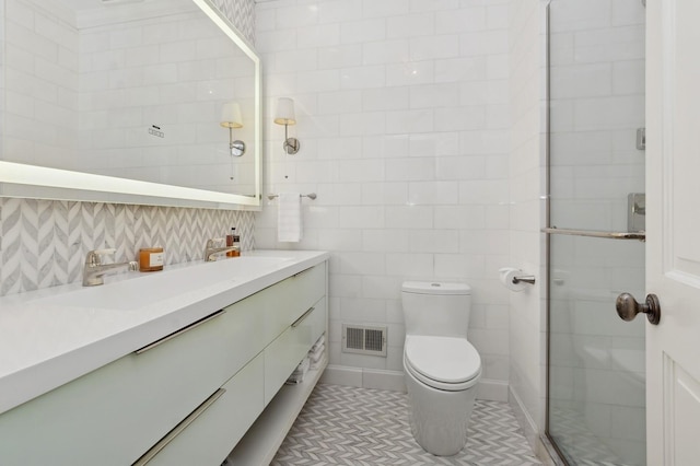 full bath featuring visible vents, toilet, tile patterned floors, vanity, and tile walls