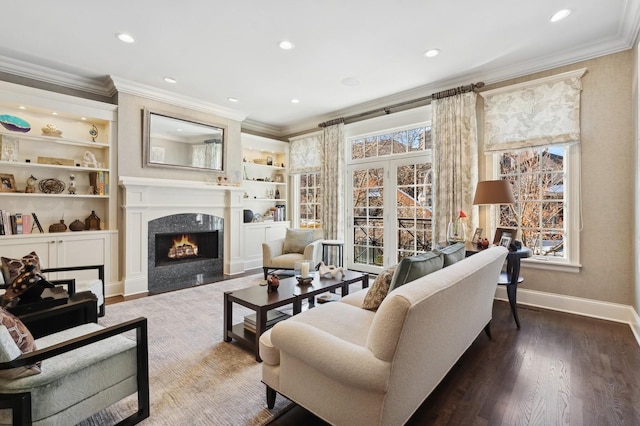 living area featuring a fireplace, ornamental molding, and wood finished floors