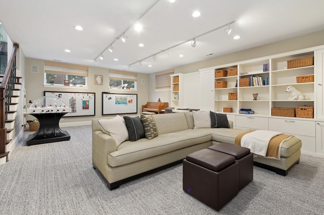 living area featuring carpet, stairway, track lighting, and recessed lighting