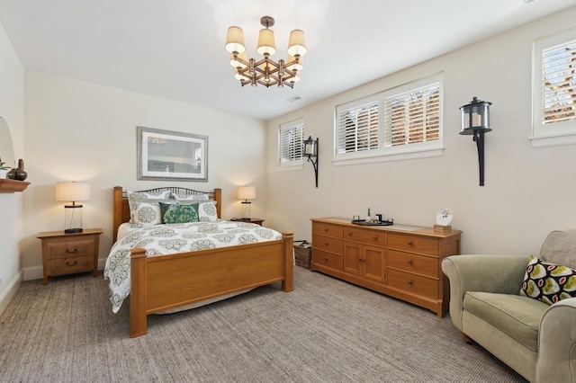 bedroom featuring a chandelier, light carpet, visible vents, and baseboards