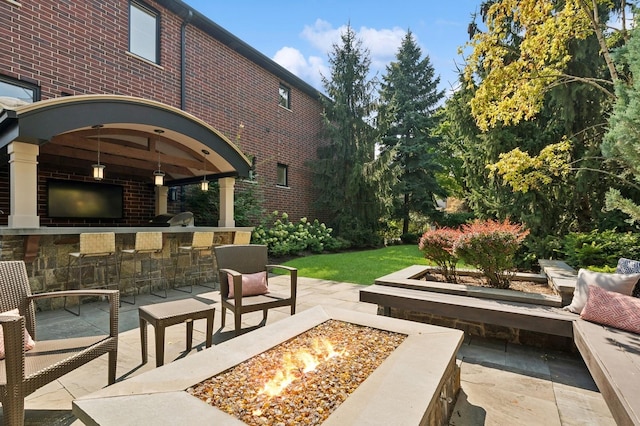 exterior space with a fire pit, a patio, exterior kitchen, and outdoor dry bar