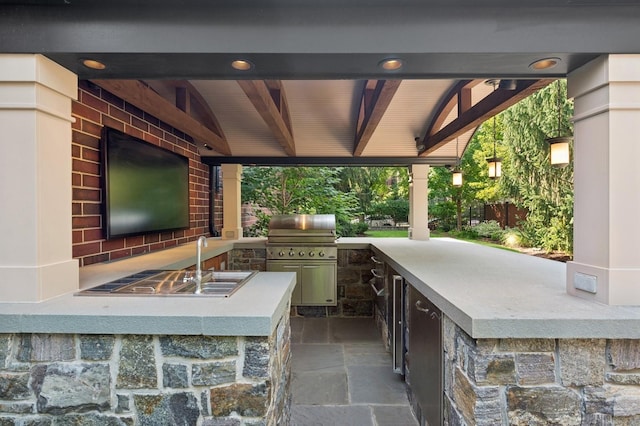 view of patio with an outdoor kitchen and outdoor wet bar