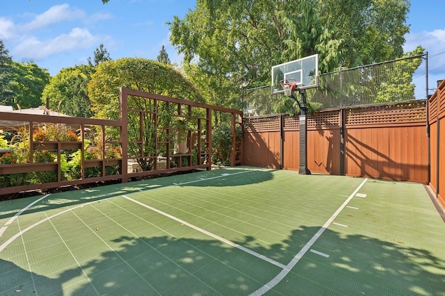 view of basketball court with fence and basketball court