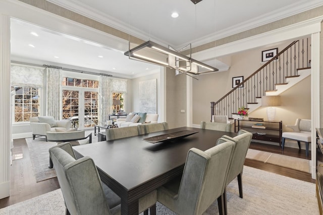 dining space featuring baseboards, wood finished floors, stairs, crown molding, and recessed lighting