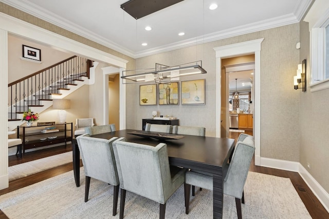 dining area featuring recessed lighting, wood finished floors, baseboards, stairway, and crown molding