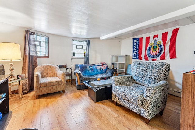 living area with light wood-type flooring, baseboards, and baseboard heating