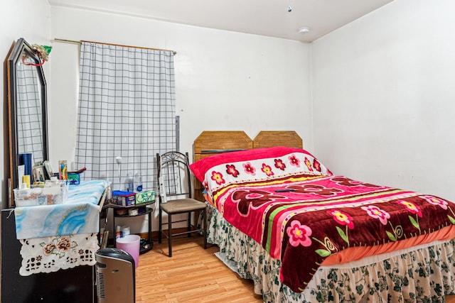 bedroom with wood finished floors