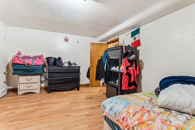 bedroom featuring baseboards and wood finished floors