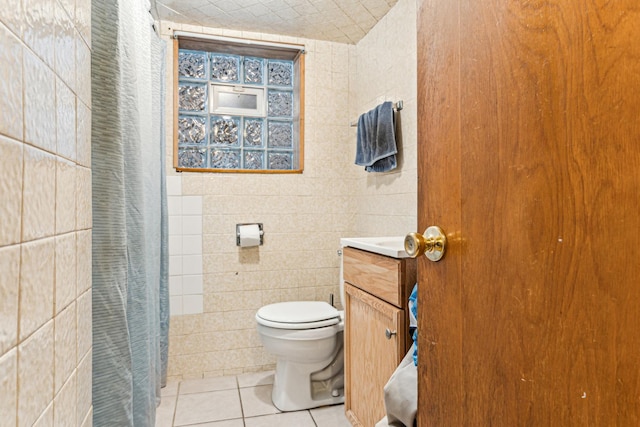 full bath with tile patterned floors, toilet, a shower with shower curtain, tile walls, and vanity