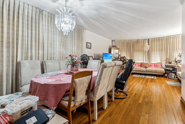 dining area with an inviting chandelier and hardwood / wood-style flooring