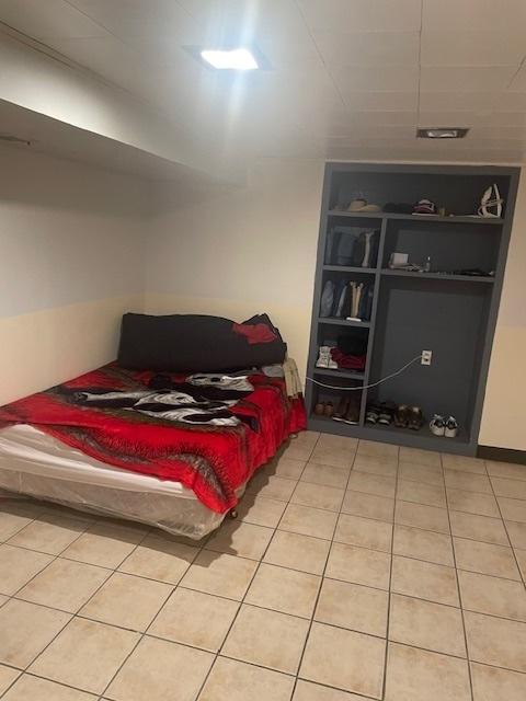 bedroom featuring light tile patterned floors