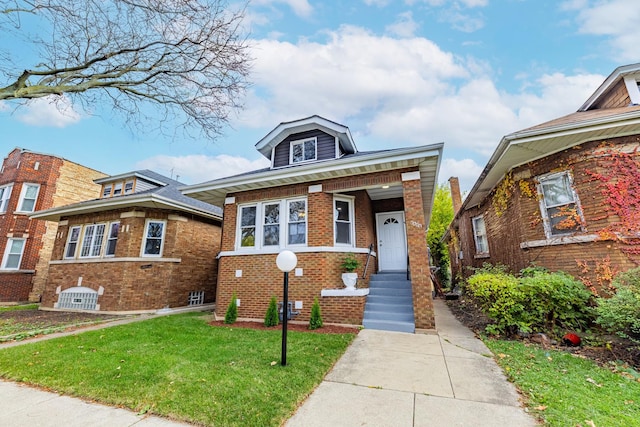 view of front of home featuring brick siding and a front lawn