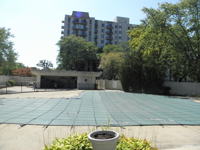 community pool featuring fence and a patio