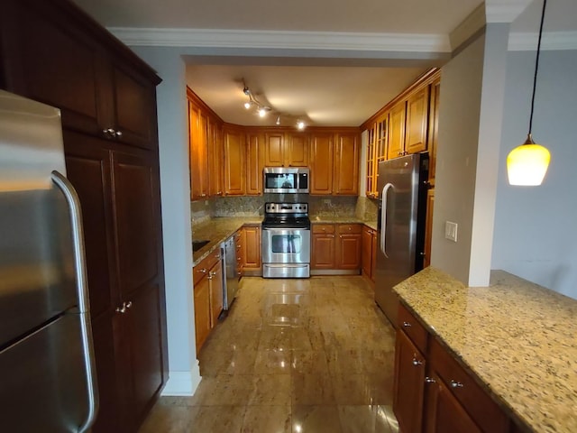 kitchen with ornamental molding, stainless steel appliances, tasteful backsplash, and brown cabinetry