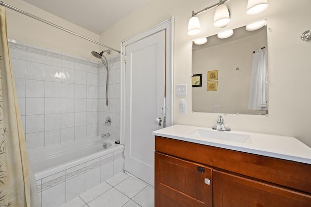 bathroom with tile patterned flooring, vanity, and tiled shower / bath