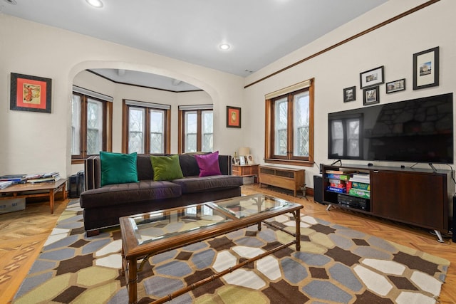 living room featuring recessed lighting, arched walkways, and radiator heating unit