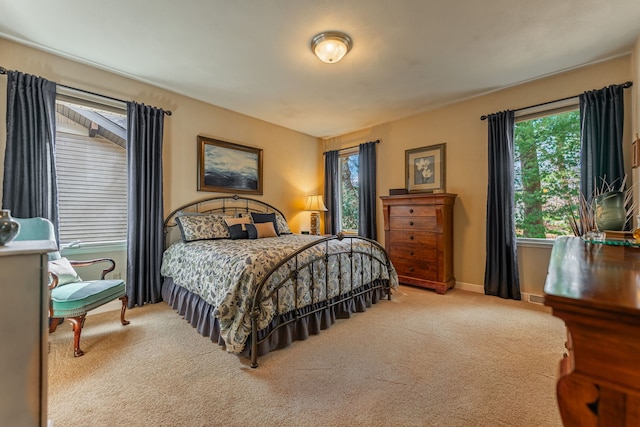 carpeted bedroom featuring visible vents and baseboards