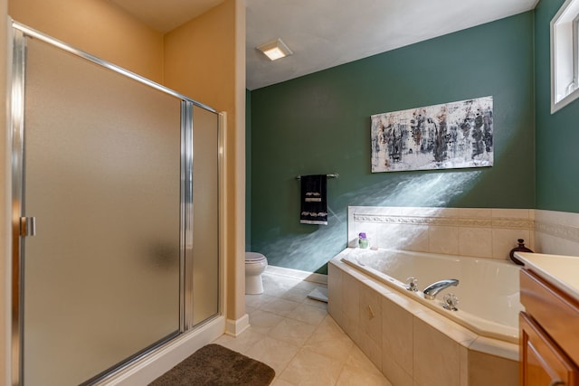 bathroom featuring tile patterned flooring, a shower stall, vanity, and a garden tub