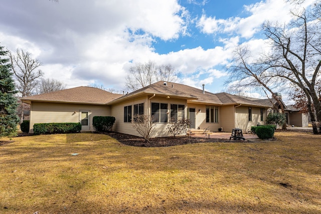 rear view of property featuring a lawn and a patio area