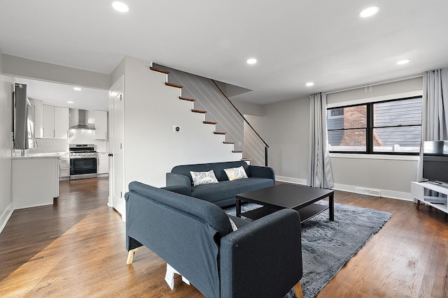 living room featuring visible vents, recessed lighting, stairs, and wood finished floors