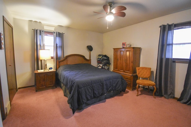 bedroom featuring baseboards, a ceiling fan, and light colored carpet