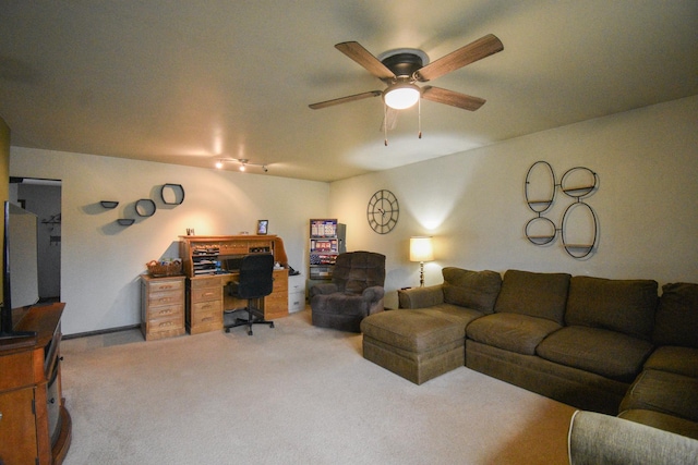 living area with carpet and a ceiling fan