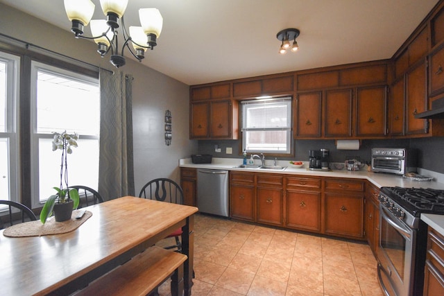 kitchen featuring a toaster, a notable chandelier, a sink, light countertops, and appliances with stainless steel finishes