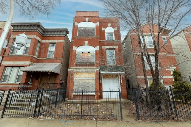 view of front of house featuring a fenced front yard and brick siding