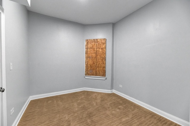 spare room with baseboards