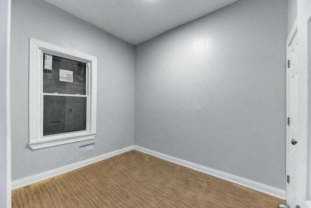 unfurnished room featuring wood finished floors and baseboards