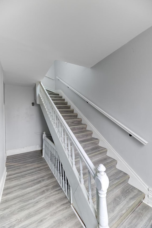 stairs with baseboards and wood finished floors